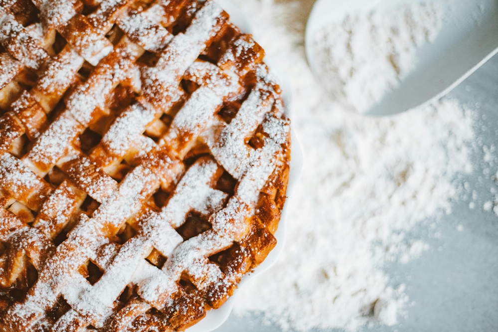 Close up if a baked pie with powder sugar on top.